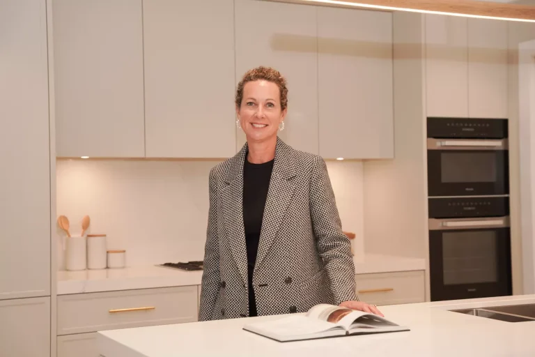 Tegan Grant, Owner of FurnishX standing in a kitchen